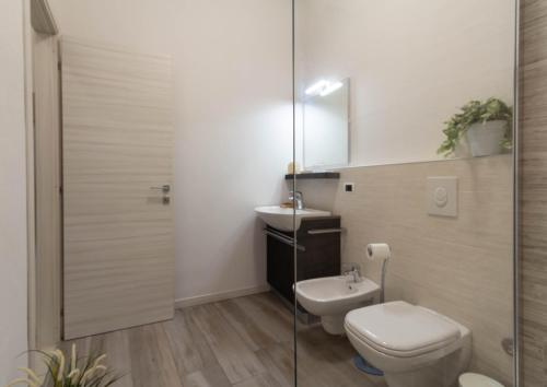 a bathroom with a toilet and a sink at Le Casette Di Osvaldo in Lecco