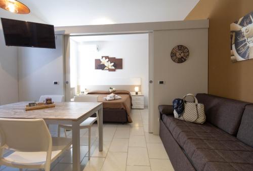 a living room with a couch and a table at Le Casette Di Osvaldo in Lecco
