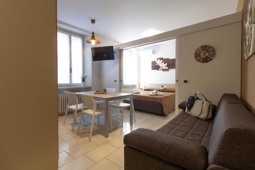 a living room with a couch and a table at Le Casette Di Osvaldo in Lecco
