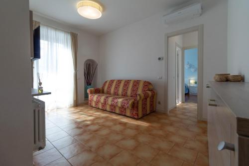 a living room with a couch and a window at Le Casette Di Osvaldo in Lecco