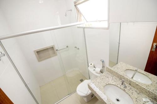 a bathroom with a shower and a sink and a toilet at Rio das Pedras Thermas Hotel in Caldas Novas