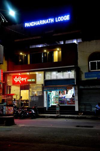 a store front of a building at night at Pandharinath Lodge in Pandharpur