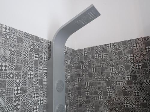 a bathroom with a shower with a tile wall at Officina Rooms in Como