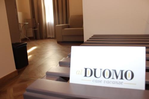 a room with two beds with a sign on it at Case Vacanze Al Duomo in Licata