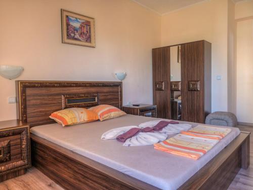 a bedroom with a large bed with two pillows at Hotel Fantasy Beach in Sveti Vlas