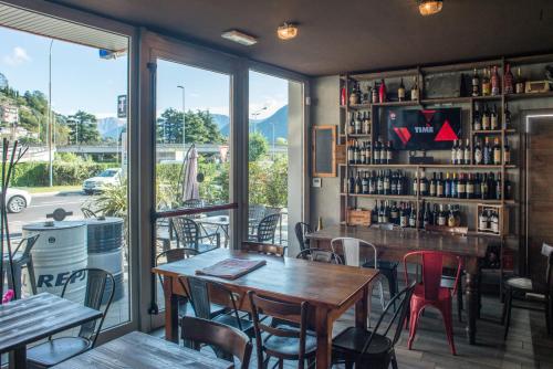 a restaurant with tables and chairs and a bar at Officina Rooms in Como