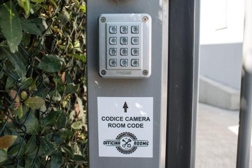 a close up of a remote control on a phone booth at Officina Rooms in Como