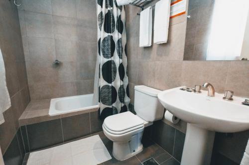 uma casa de banho com um WC branco e um lavatório. em Milhouse Hostel Hipo em Buenos Aires