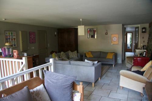 a living room with couches and chairs at Maison Caramel in Landry