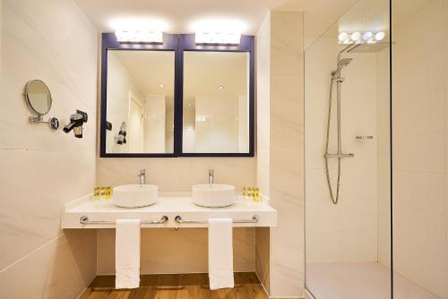 
a bathroom with a sink, toilet and shower at Eurostars Málaga in Málaga
