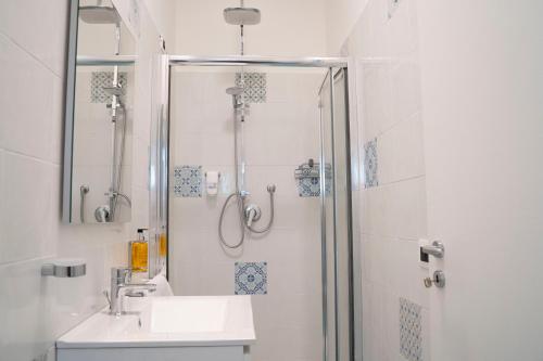 a bathroom with a shower and a sink at Villa Pietra Rossa in Diamante