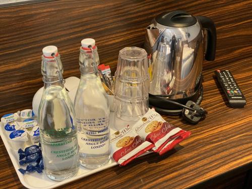 a table with a bottle of water, a bottle of soap, and a at Crestfield Hotel in London