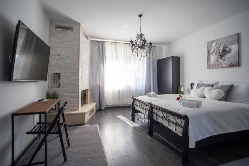 a bedroom with a bed and a desk in it at Diamond Palace in Varaždin