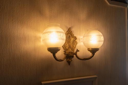 a light on a wall with two lights on it at Kagura White Horse Inn in Yuzawa