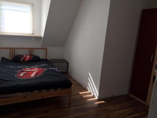 a small bedroom with a bed and a window at Ferienwohnung Sauerländer in Plettenberg