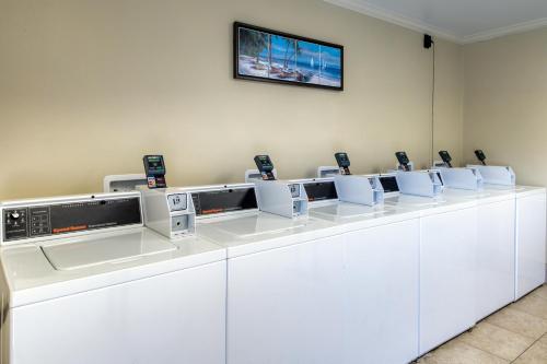 a row of white counters with a tv on the wall at Plantation Dunes II in Gulf Shores