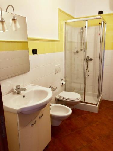a bathroom with a sink and a toilet and a shower at Sal&Love apt in Porto Antigo in Santa Maria