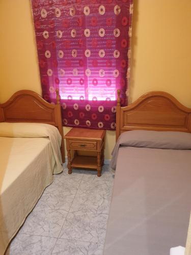 Cama o camas de una habitación en Hostal la Horra