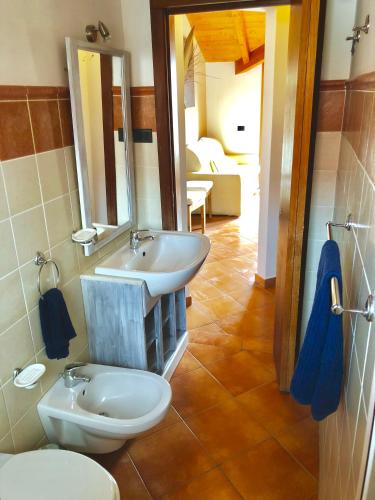 a bathroom with a white toilet and a sink at Sal&Love apt in Porto Antigo in Santa Maria