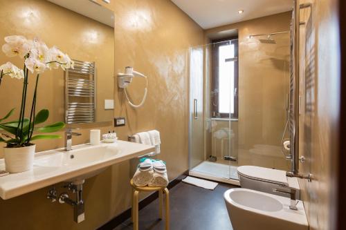 a bathroom with a sink and a toilet and a shower at Il Melograno Relais in Vico Equense