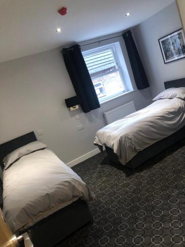 A bed or beds in a room at Bay horse hotel