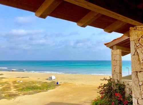 a view of a beach with the ocean in the background at Sal&Love apt in Porto Antigo in Santa Maria