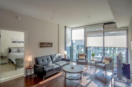 a living room with a couch and a table at Atlanta Furnished Apartments - Great location in the Heart of the City in Atlanta