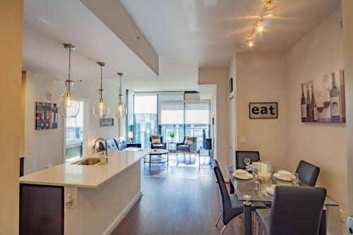a kitchen and living room with a table and chairs at Atlanta Furnished Apartments - Great location in the Heart of the City in Atlanta