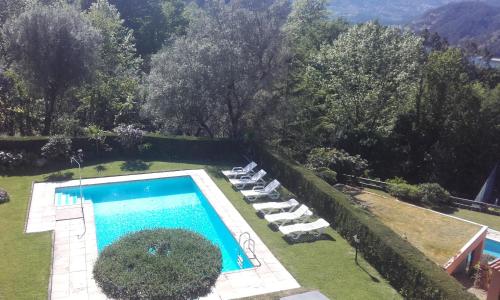 an aerial view of a swimming pool with lounge chairs at Geres Nature House, casa das pedras in Vieira do Minho