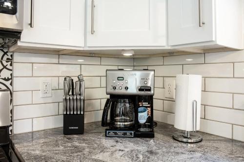a coffee maker on a counter in a kitchen at Lavish Living - 8 mins from Braves Stadium w/King in Smyrna