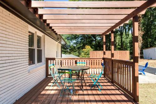 a patio with a table and chairs on a deck at Lavish Living - 8 mins from Braves Stadium w/King in Smyrna