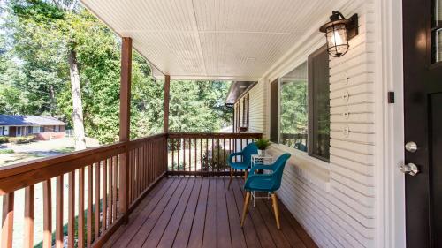 a porch with two chairs and a table on it at Lavish Living - 8 mins from Braves Stadium w/King in Smyrna
