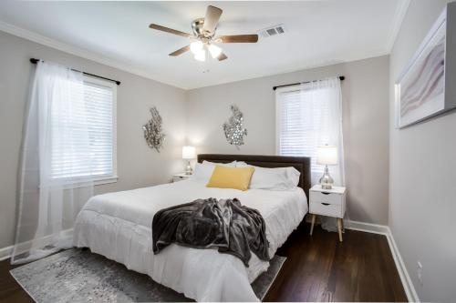 a bedroom with a bed and a ceiling fan at Lavish Living - 8 mins from Braves Stadium w/King in Smyrna