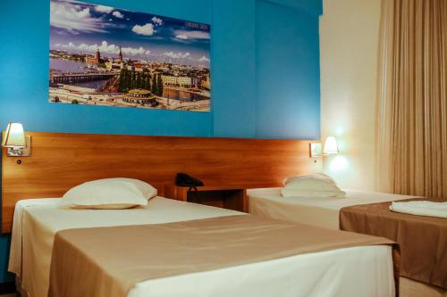 Tempat tidur dalam kamar di Tri Hotel Smart Criciuma
