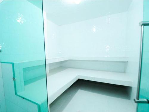 a bathroom with a shower with a glass door at Villeta Boutique Hotel Spa in Villeta