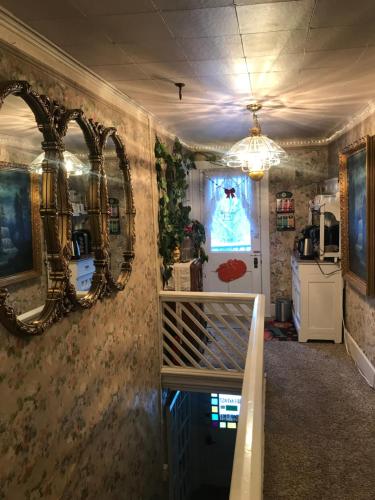 a room with mirrors on the wall and a staircase at Historic Windsor in Silver Plume