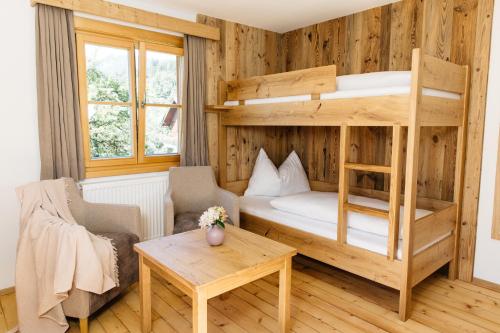a room with a bunk bed and a table at Ferienhaus Bognerhof in Sankt Veit im Pongau