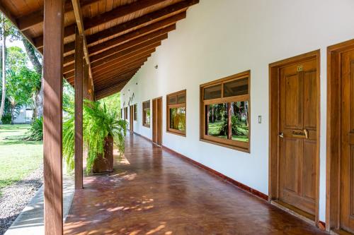 an empty hallway of a building with wooden doors at Nanajuana Río Dulce in Rio Dulce