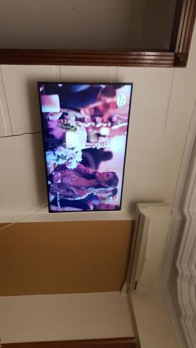 a flat screen tv sitting on top of a wall at mody appartment at alexandria in Alexandria
