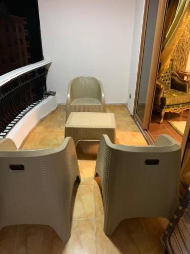 a room with two chairs and a piano at mody appartment at alexandria in Alexandria
