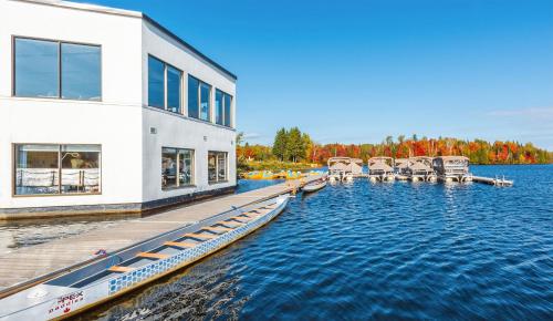 a house on the water with a dock at Estérel Resort in Esterel