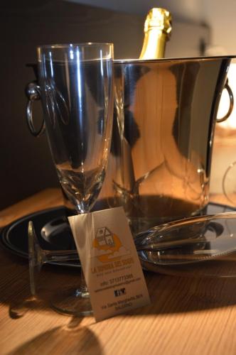 a wine glass sitting on top of a table at La Dimora Dei Sogni in Salerno