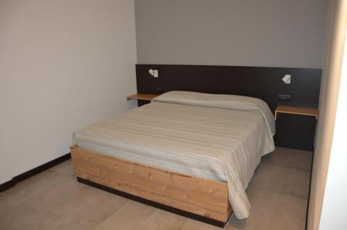 a small bed in a bedroom with a wooden frame at La Dimora Dei Sogni in Salerno