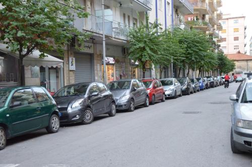 a row of cars parked on the side of a street at La Dimora Dei Sogni in Salerno