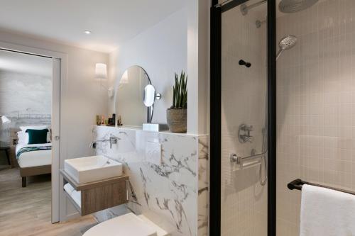 a bathroom with a shower and a toilet and a sink at Citadines Confluent Nantes in Nantes