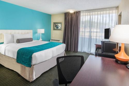 a hotel room with a large bed and a desk at Hotel 505 in Albuquerque