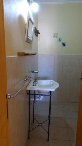 a bathroom with a sink and a shower at Duplex en Necochea in Necochea