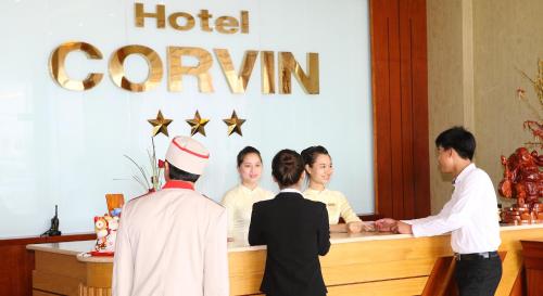 a group of people standing around a hotel counter at Corvin Hotel in Vung Tau