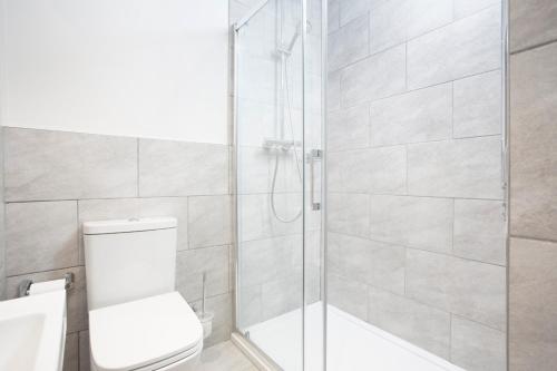 a bathroom with a glass shower with a toilet at Boat House in Whitstable