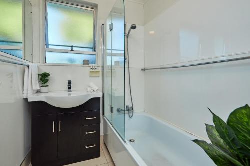 a bathroom with a sink and a shower at Seas The Day In Kaikoura - Book Now! in Kaikoura